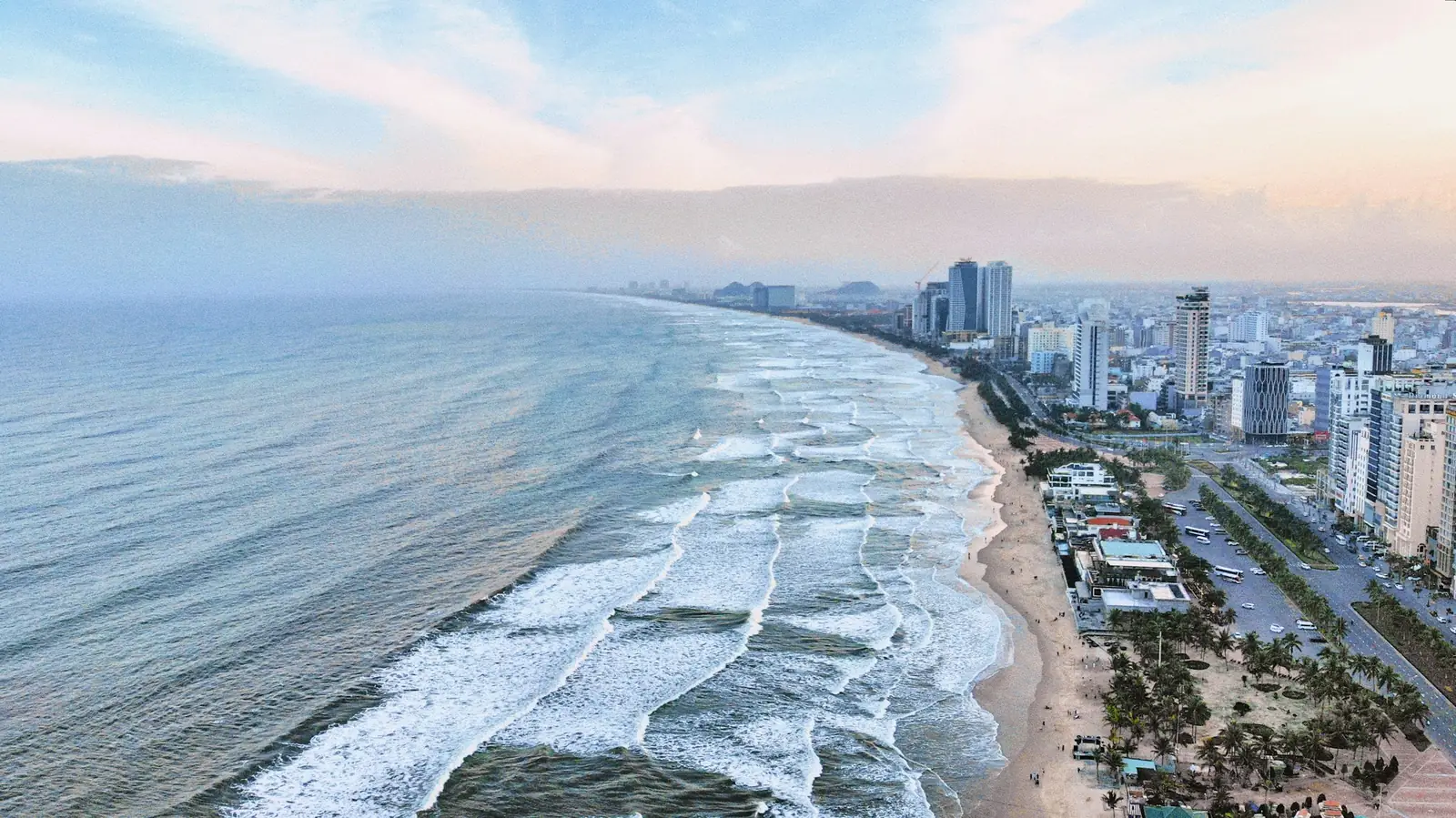 Da Nang's beach and seafront from above, with waves rolling in